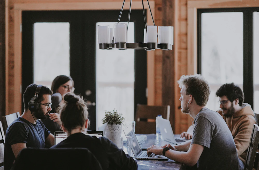 Small team meeting around a table in a warm workspace