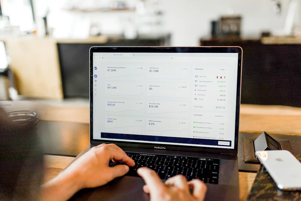 Hands on a laptop showing an analytics dashboard